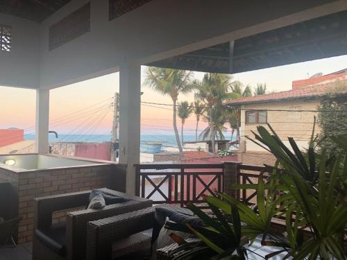 a patio with a view of the ocean from a house at Pousada do Holandês in Canoa Quebrada