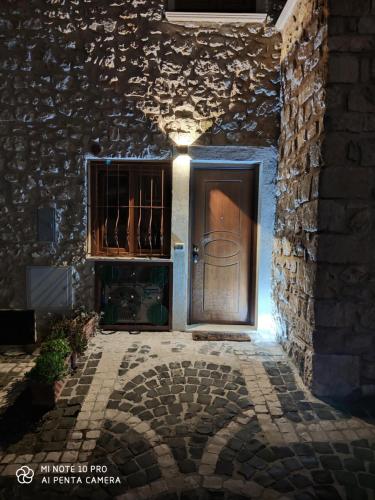 an entrance to a building with a wooden door at La Cantina di Giuliano in Falvaterra
