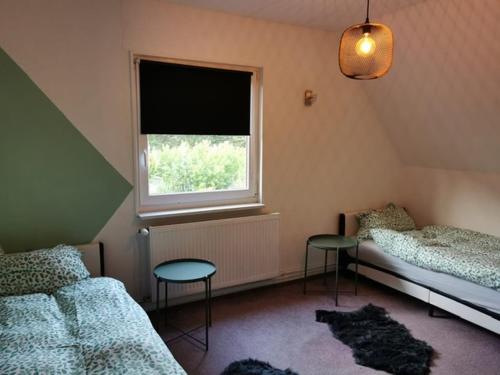 a bedroom with two twin beds and a window at Heide Schnack in Soltau