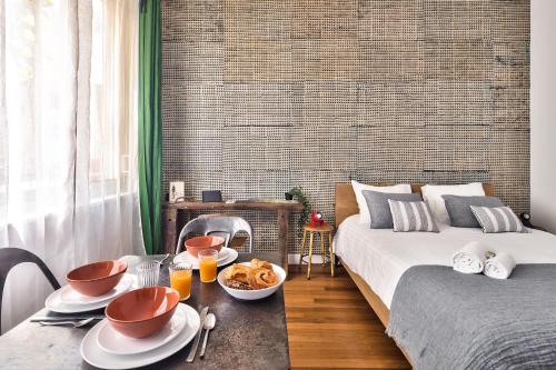 a bedroom with two beds and a table with food on it at Studio of Liberty in Paris
