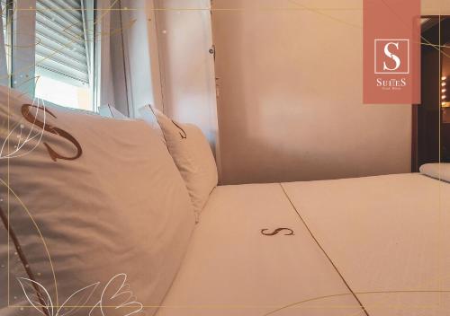 a room with two pillows sitting next to a window at Yellow Suites in Cascais