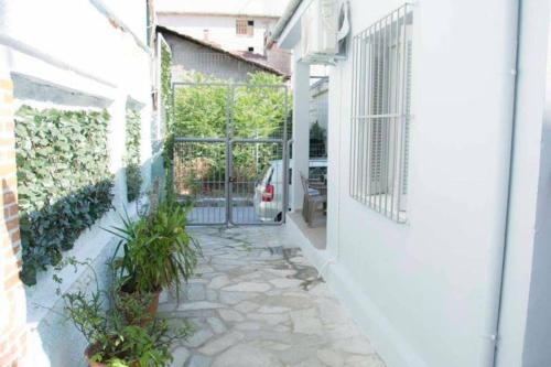 a courtyard of a building with a gate and plants at City Hall House in Volos