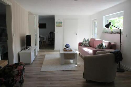 a living room with a couch and a tv at FeWoGeestland in Bremerhaven