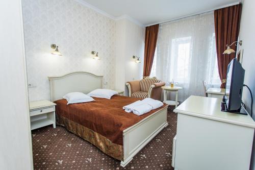 a hotel room with a bed and a bathroom at GRK "Master" in Vlasovka