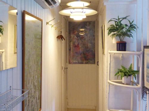 a hallway with a door and a potted plant at Holiday home Glesborg XL in Glesborg