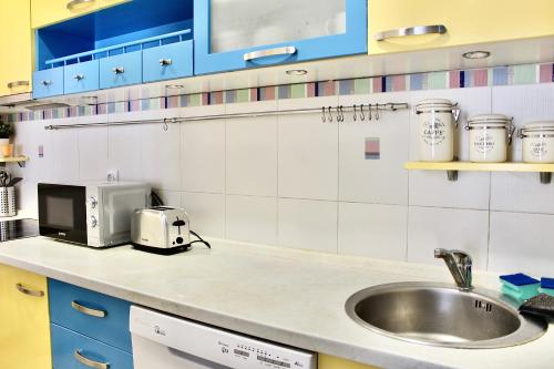 a kitchen with a sink and a microwave at Ramonda Residences - New Belgrade in Belgrade