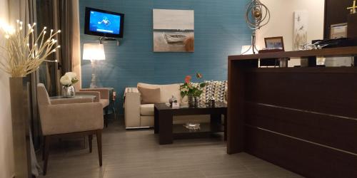 Onira Boutique في تولو: غرفة معيشة مع أريكة وكرسي