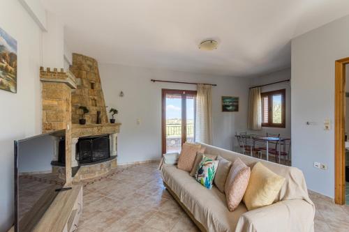 a living room with a couch and a fireplace at Chioureas apartments in Levktron