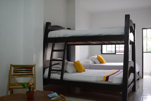 two bunk beds in a room with a table at Balcones del Ayer in Salento