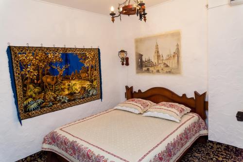 a bedroom with a bed and a painting on the wall at Hotel General in Ekibastuz