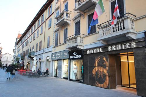 a building with a hotel entrance on a street at Hotel Fenice in Milan