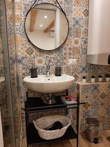 a bathroom with a sink and a mirror at Al Sottano 19 in Bari