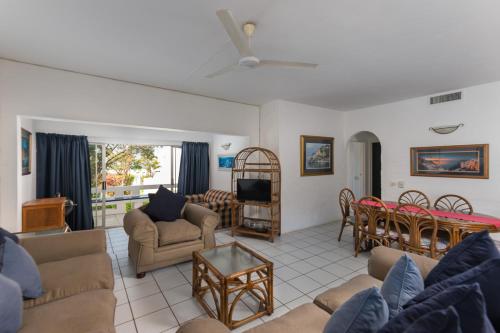 a living room with couches and a dining room at Santorini - Akrotiri 3 in Ballito