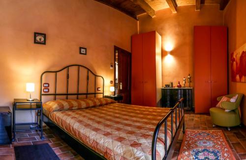 a bedroom with a bed and a chair in a room at La Puraza Comfort Rooms in Rimini