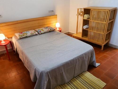 a bedroom with a large bed with a wooden headboard at APPARTEMENT AGATHOIS-2 in Agde