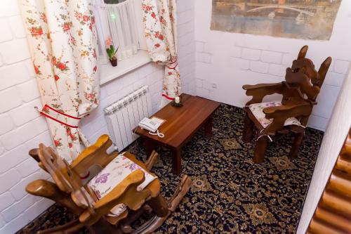 a room with two wooden chairs and a table at Hotel General in Ekibastuz