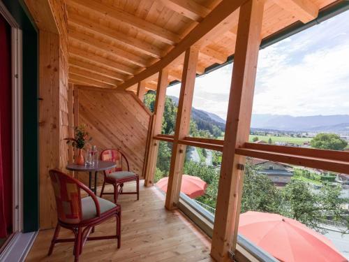 a room with a table and chairs and a large window at Be 550 in Wörgl