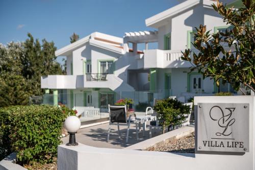 a building with a sign in front of it at Villa Life in Agia Marina Nea Kydonias