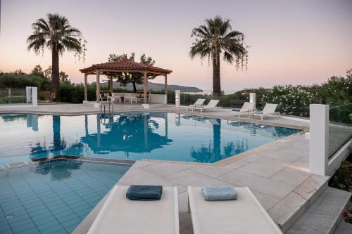 a swimming pool with lounge chairs and a gazebo at Villa Life in Agia Marina Nea Kydonias