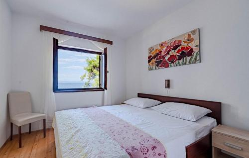 a white bedroom with a bed and a window at Apartmani Pipin - Prigradica, kod Caffe Tempera in Prigradica