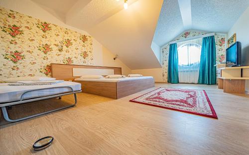 a large room with two beds and a window at Pension Onix Vienna Airport in Maria Ellend