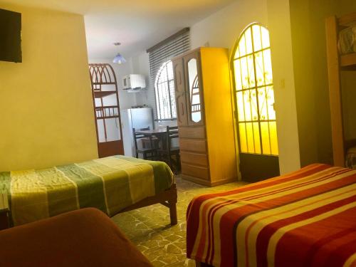a hotel room with two beds and a table at Cieneguilla MolinoVerde in Cieneguilla