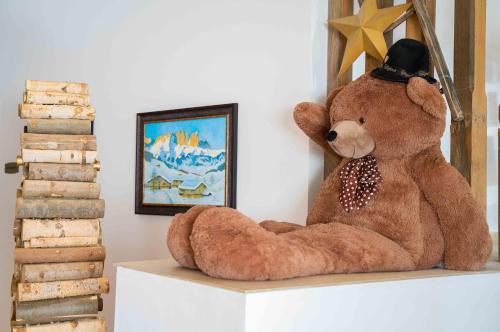 a large teddy bear sitting on top of a shelf at Teleferic Grand Hotel in Poiana Brasov