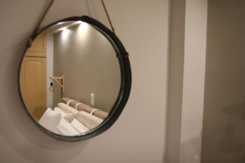 a mirror in a bathroom with white towels at Langi Apartments in Mesolongion