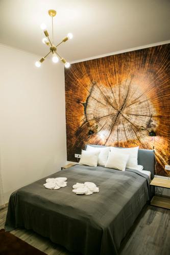 a bedroom with a large bed with towels on it at Marusius Apartmanház in Makó