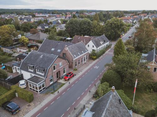 an aerial view of a town with houses and a street at Bed & Breakfast Bloemen Vertellen in Elst