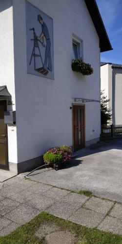 a building with a picture of a man on a ladder at Appartement Veronika in Öblarn