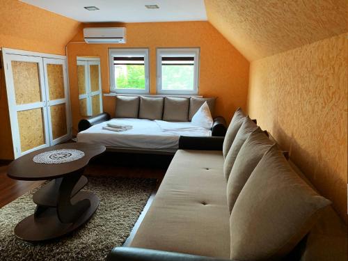 a living room with a couch and a table at Prie Ąžuolo in Zarasai
