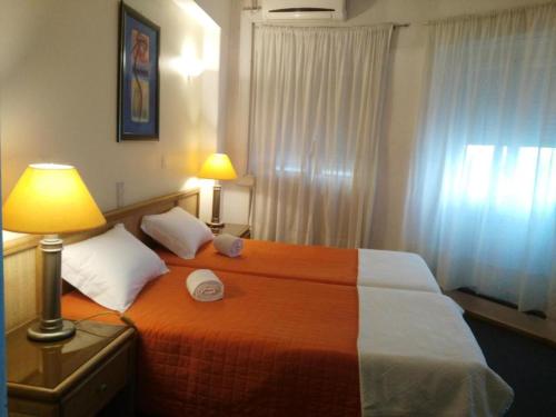リスボンにあるA Ponte - Saldanhaのベッドルーム1室(ベッド1台、ランプ、窓付)