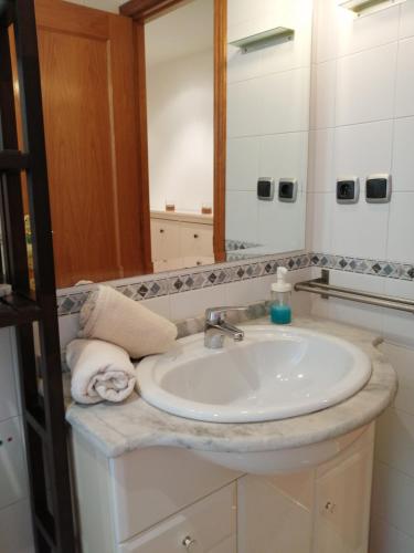 a bathroom with a sink and a mirror at APARTAMENTO HUESCA in Huesca