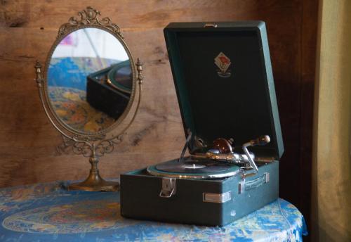 a suitcase sitting on a table next to a mirror at Ethno Sazano Hotel in Sazano