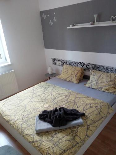 a bed with a blanket on it in a bedroom at Landhaus Tirol in Presseggersee