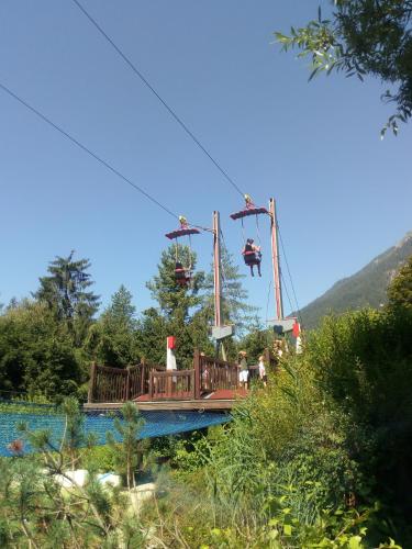 a roller coaster on a bridge with people on it at Landhaus Tirol in Presseggersee