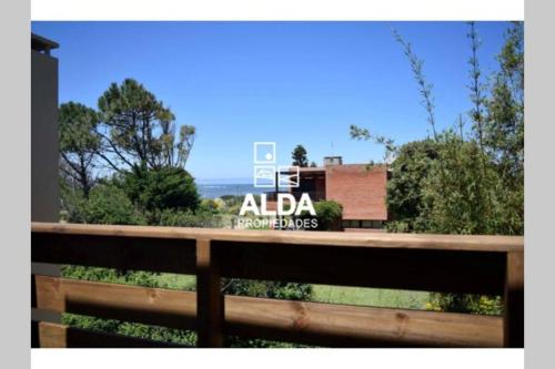 a wooden fence with a sign on the side of a building at BAHIA SAN FRANCISCO, casa Gaviotas, a 80 metros del mar, Uruguay in Piriápolis