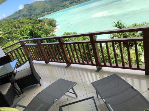 a balcony with chairs and a view of the ocean at Sailfish Beach Villas in Anse a La Mouche
