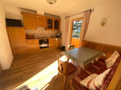 a living room with a table and a kitchen at Haus Wildspitz in Neustift im Stubaital