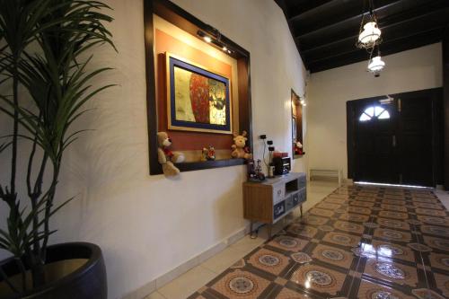 a hallway with a potted plant and a black door at Vista Rio - Scenic River View, Walk to Jonker St in Melaka