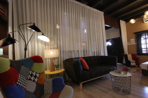 a living room with a couch and a chair at Vista Rio - Scenic River View, Walk to Jonker St in Melaka