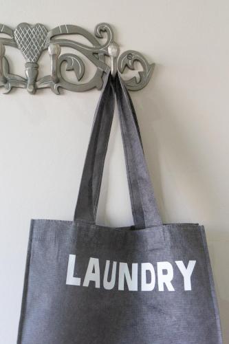 a bag with laundry written on it hanging on a wall at De Akker Guest House Oudtshoorn in Oudtshoorn