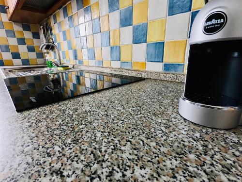 a kitchen with a counter top and a tile floor at "Sweet Life" Casa Vacanze in Lipari