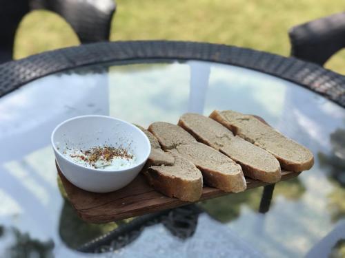 a plate of bread and a bowl of dips at Maatre Yoga Retreat in Marchula