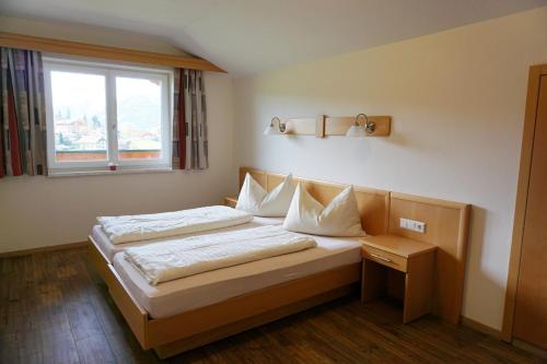 a bed in a room with a window at Aparthotel Sunrise in Ramsau am Dachstein