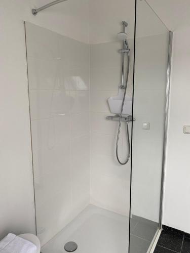 a shower with a glass door in a bathroom at Authentic Stays - 4p-apartment in Eijsden