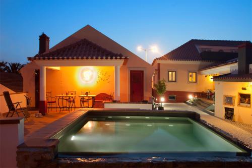 a swimming pool in the backyard of a house at Artvilla in Cadaval