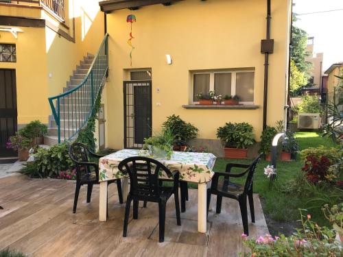 a table and chairs on the patio of a house at Appartamenti Borghetto San Donato 105 in Bologna