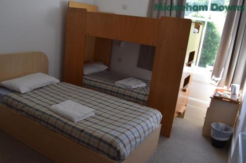 A bed or beds in a room at FSC Juniper Hall Hostel